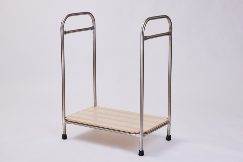A full view of a metal frame stand with a wooden platform. The stand has two metal handles at the top and is supported by four metal legs with black rubber caps. The wooden platform has a striped pattern. The background is plain white.