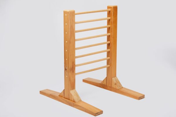 Angled view of a wooden ladder frame with smooth, rounded rungs and side rails. The ladder is made of light-coloured wood with visible grain and is supported by two horizontal stabilizing bars at the bottom, ensuring stability and balance."