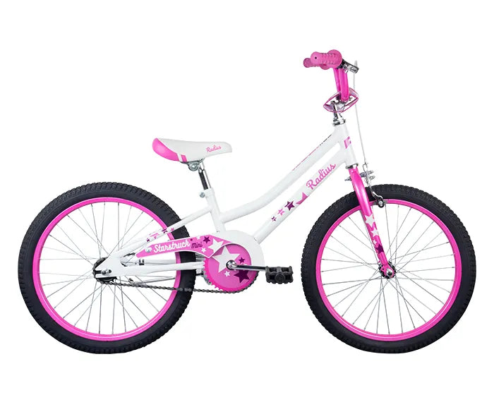 A child's bicycle with a white frame and pink accents. The bike features a pink seat, handlebar grips, and rims, with decorative stars on the frame and chain guard. The design is both vibrant and playful, ideal for a young rider.
